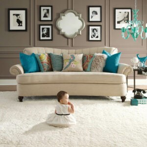 Cute baby sitting on bright carpet | Vision Flooring